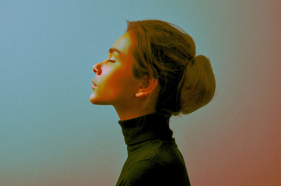 Cinematic color-graded profile portrait of a woman in warm and cool split light